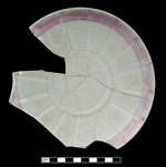 Porcellaneous molded saucer with rim painted in pink luster.
